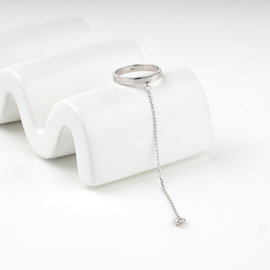 Sterling silver 925 ring with a fine chain hanging from the band