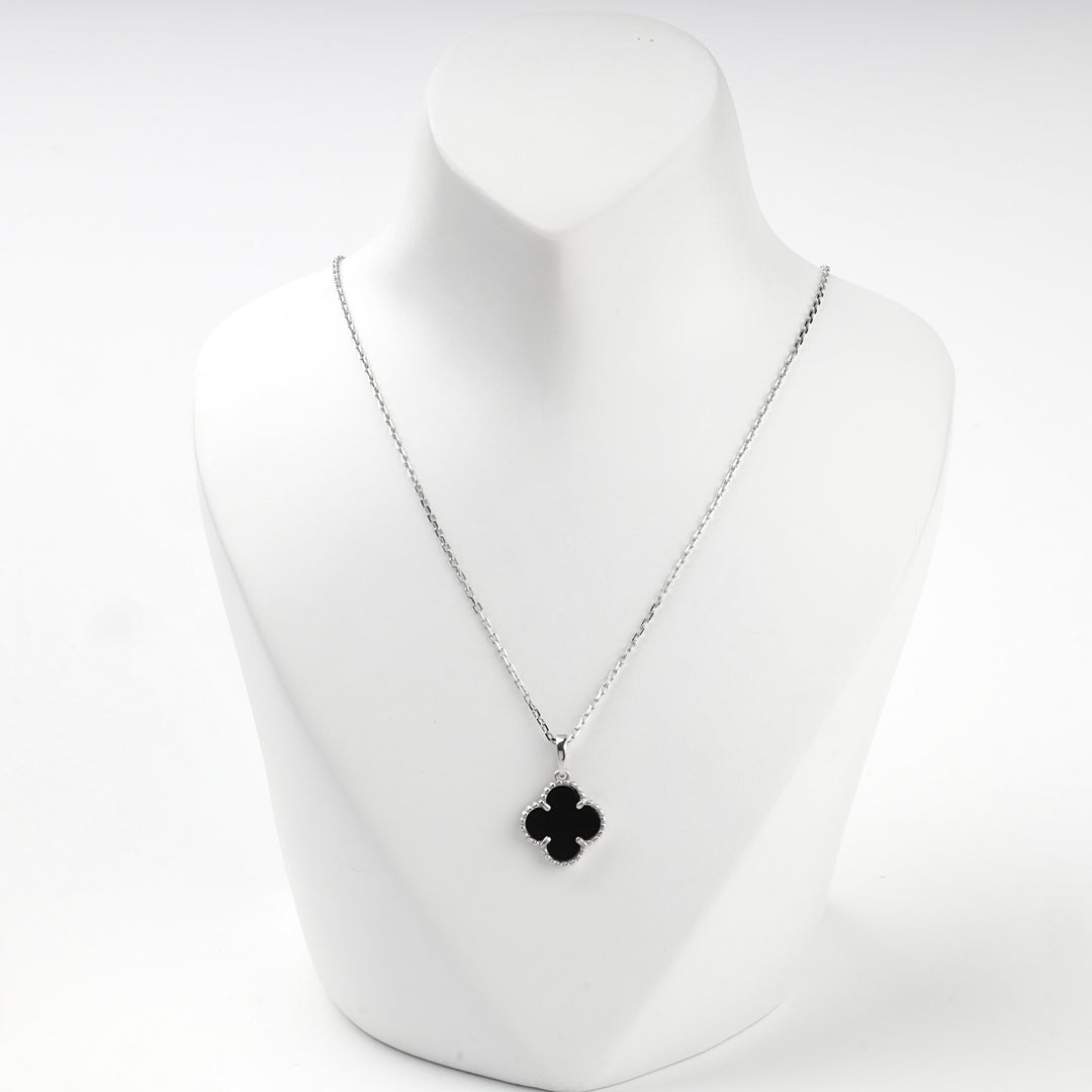 Sterling silver 925 necklace with a black onyx clover pendant on a display bust
