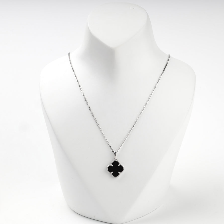 Sterling silver 925 necklace with a black onyx clover pendant on a display bust
