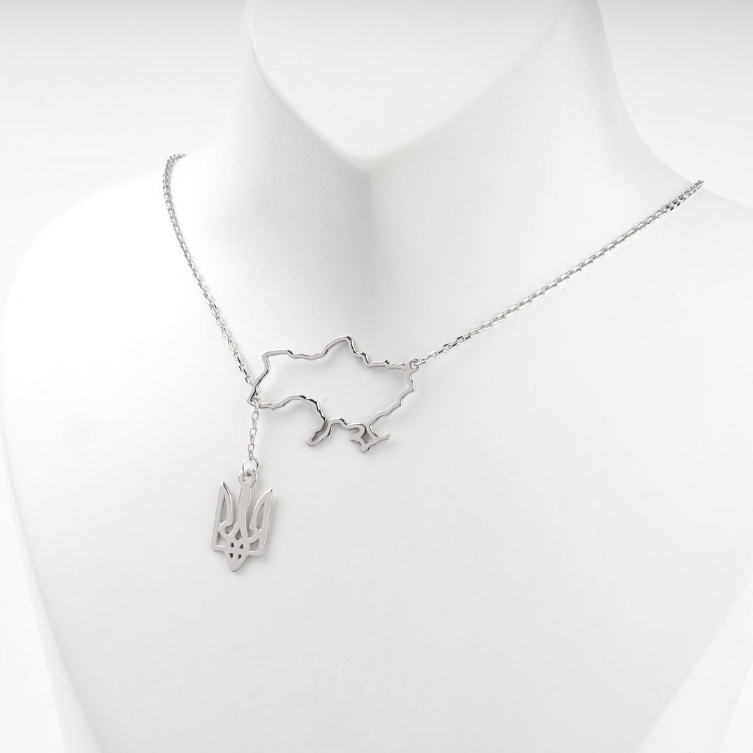 Angled view of the silver map of Ukraine and the trident pendant below it