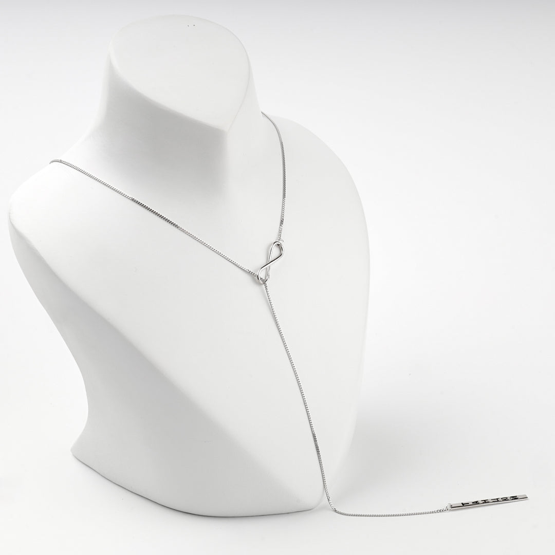 Infinity Y necklace on a white display bust, angled view