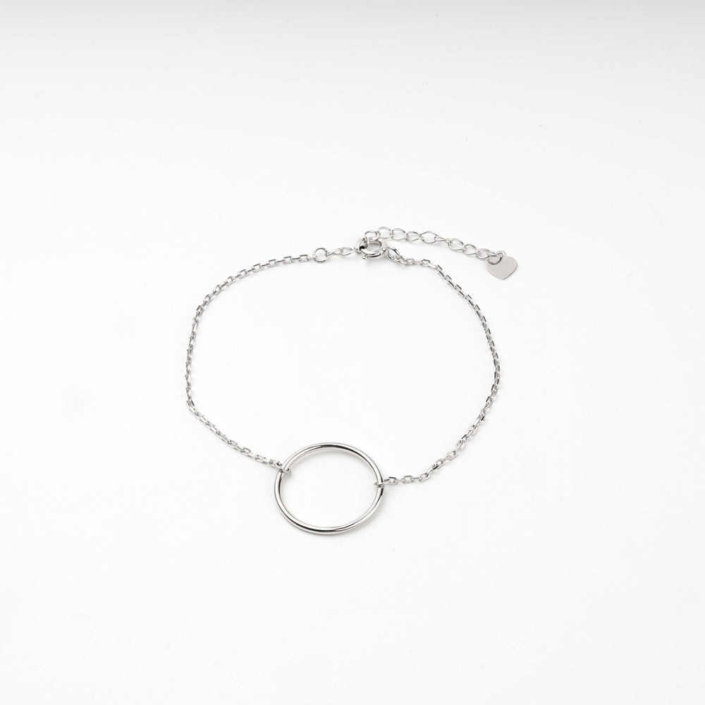 Silver 925 open circle bracelet laid flat with clasp, extender chain and heart tag