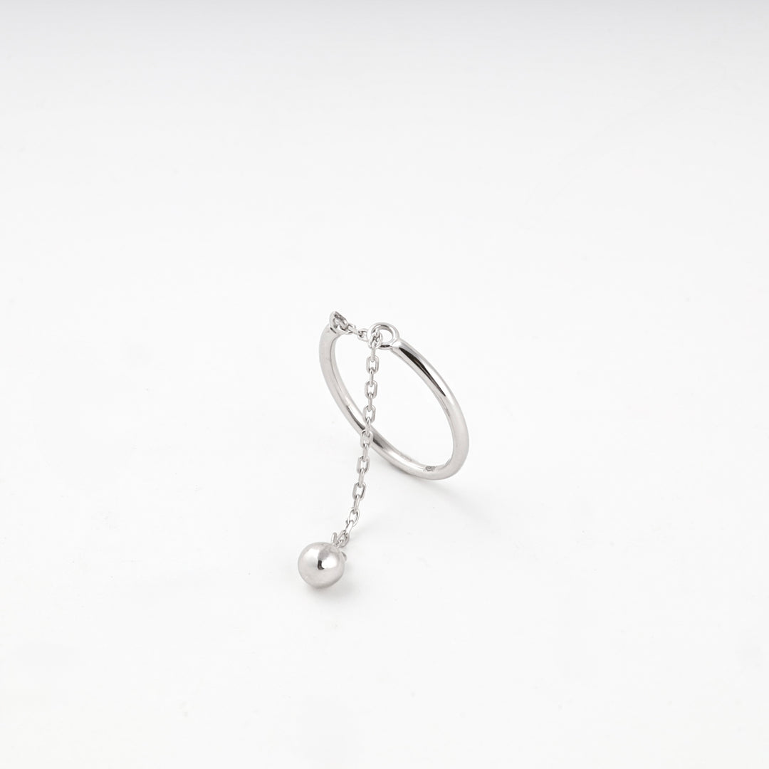 Silver 925 ring standing upright with the chain and ball hanging