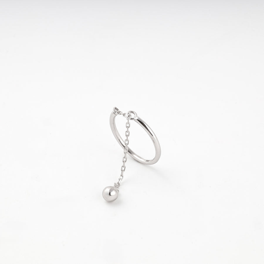 Silver 925 ring standing upright with the chain and ball hanging