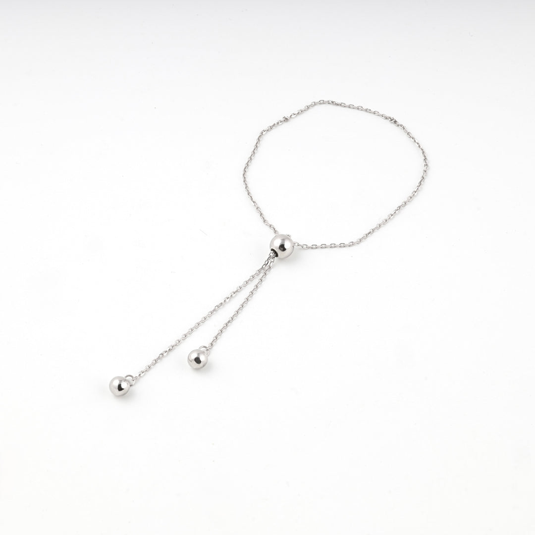 Silver 925 adjustable bracelet laid flat with its chain ends hanging