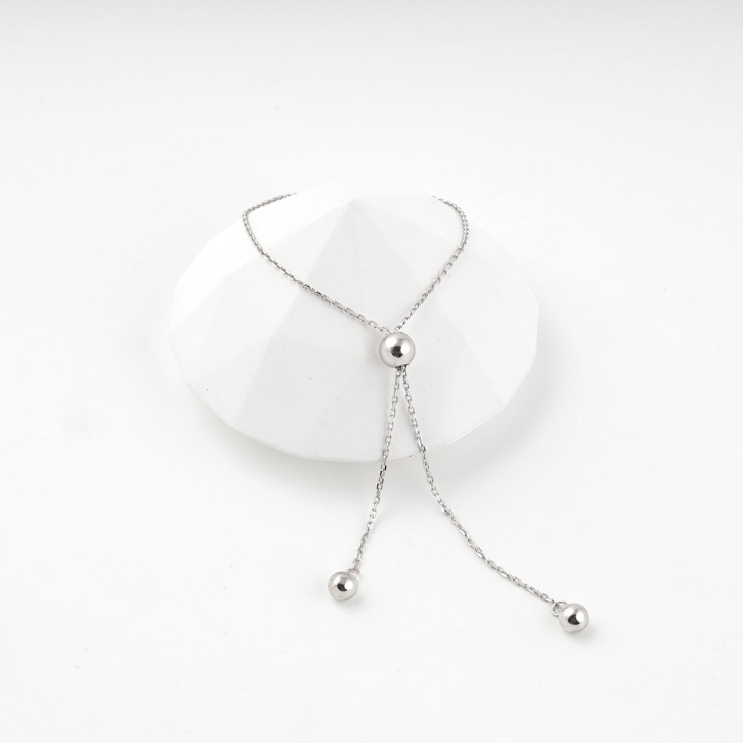 Silver 925 adjustable bracelet with its ball-tipped ends pulled through the bead