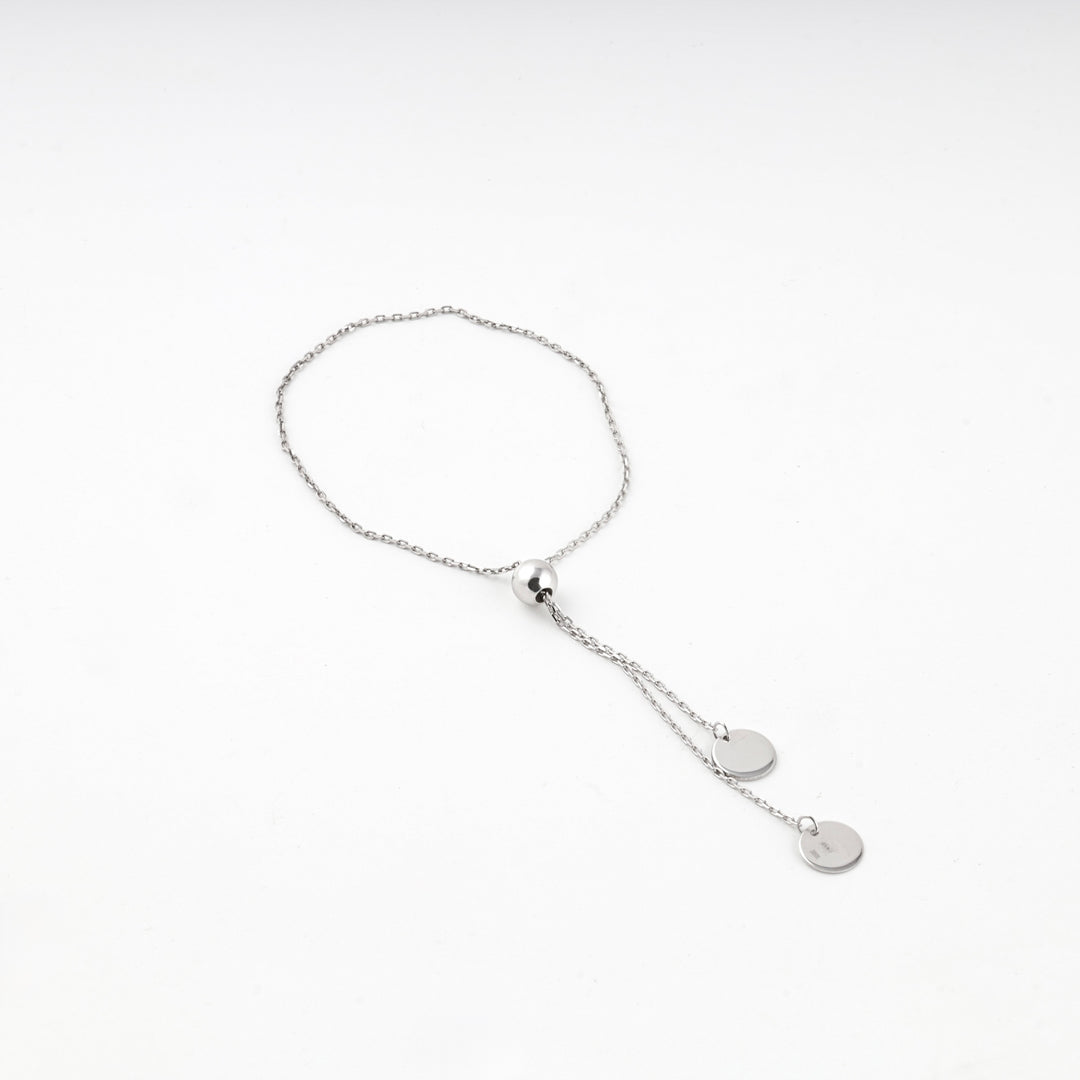 Close view of the anchor-link chain and flat silver 925 disc charm