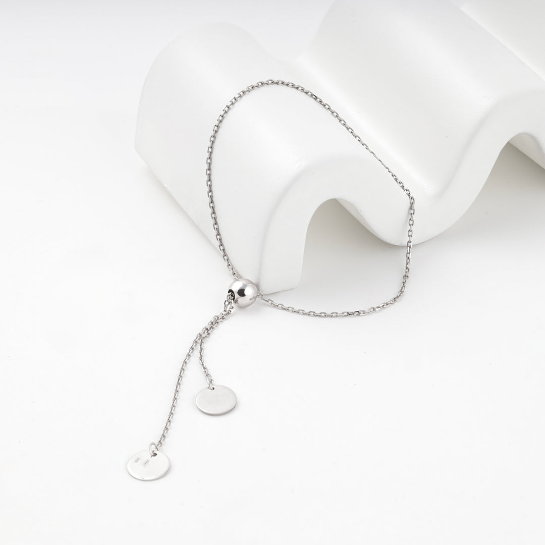Silver 925 adjustable disc bracelet laid out with both discs hanging free