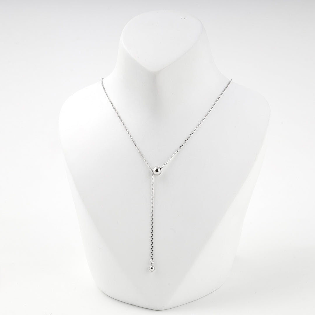 Silver 925 ball drop Y necklace on a white display bust