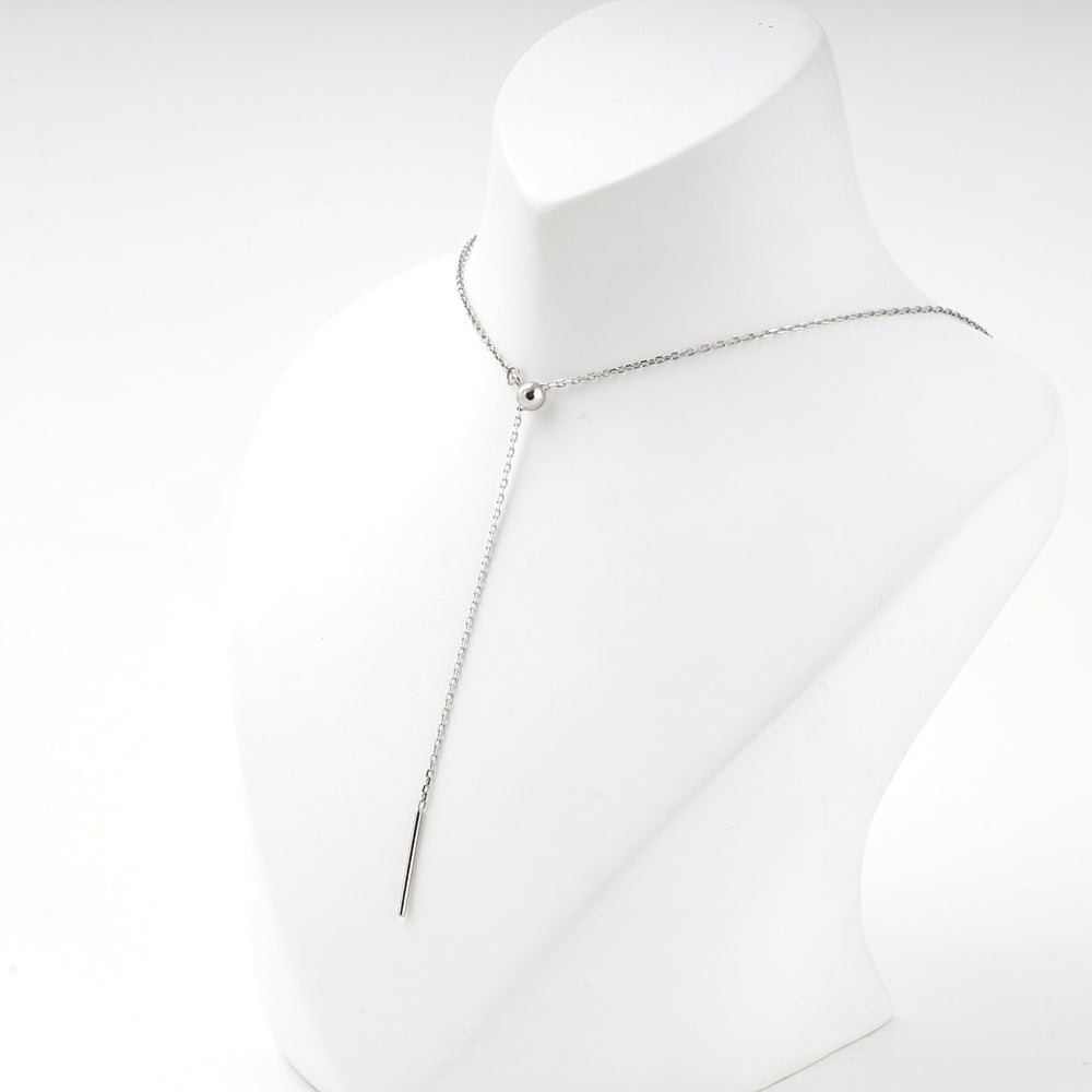 Y necklace with the bar hanging at the front of the display bust
