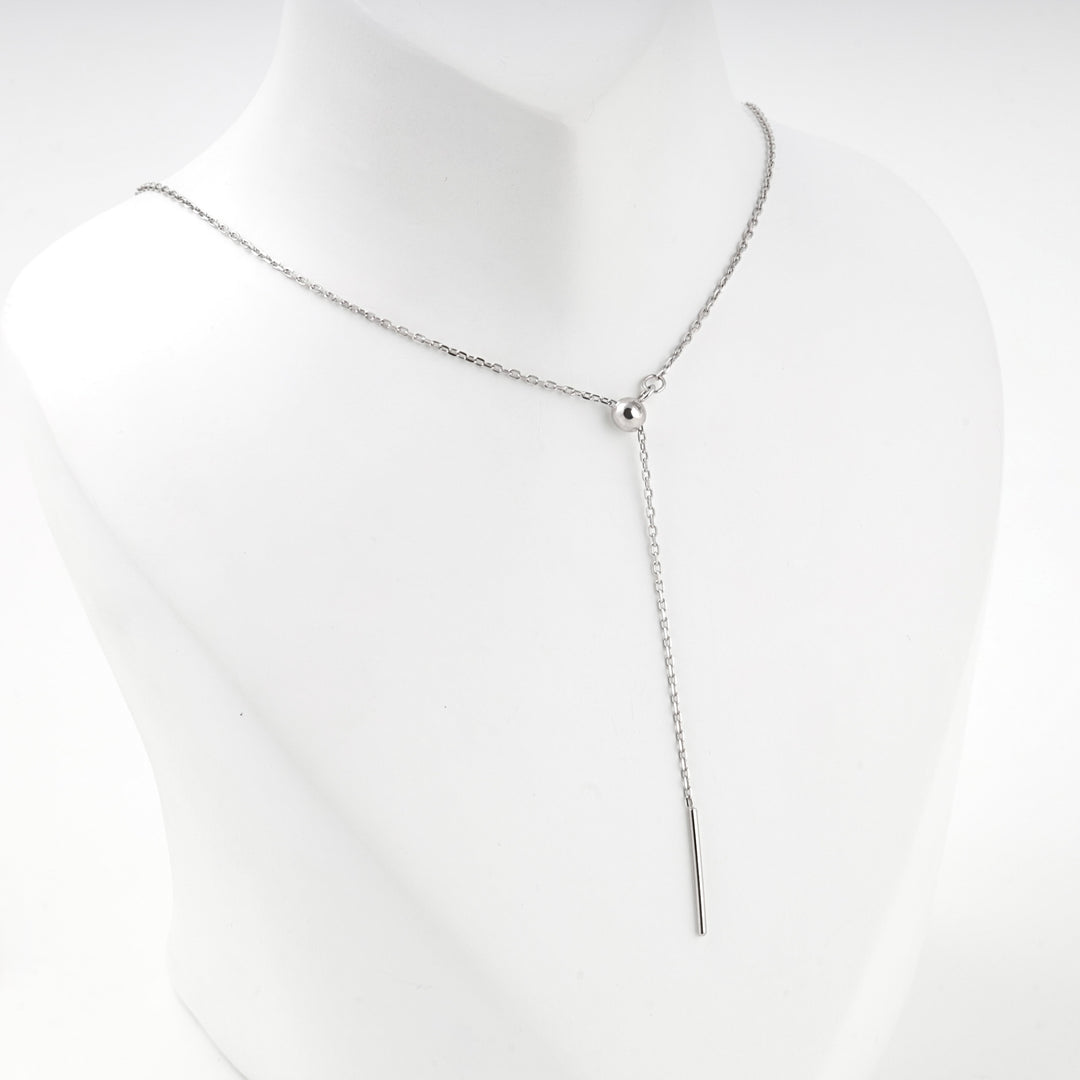 Bar drop Y necklace worn at the base of the neck, front view