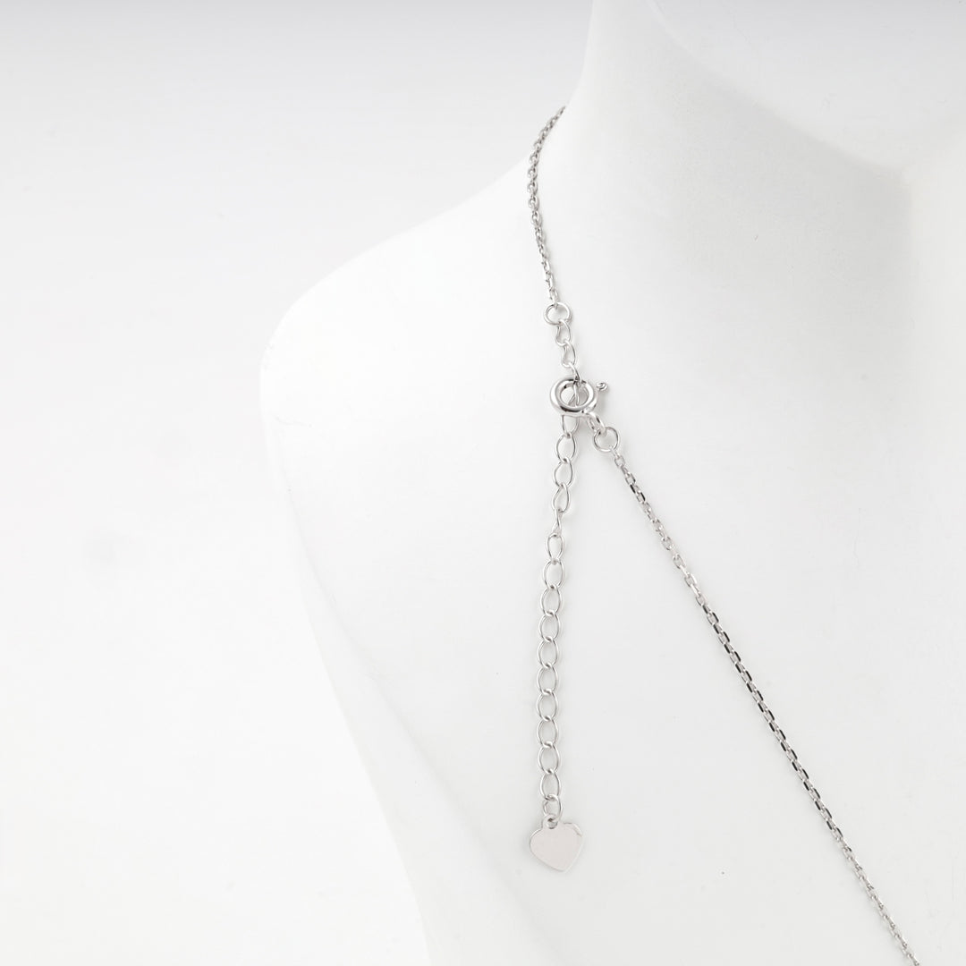 Back of the necklace showing the clasp, extender chain and round tag