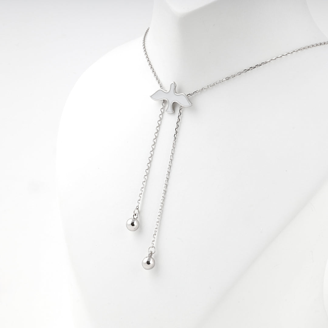 Bird necklace seen from the side with the ball drops hanging