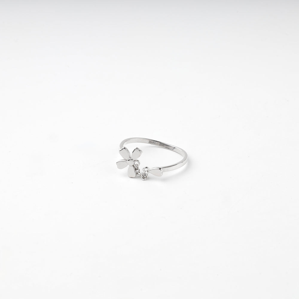 Flower ring lying flat showing the petals and the hanging charm