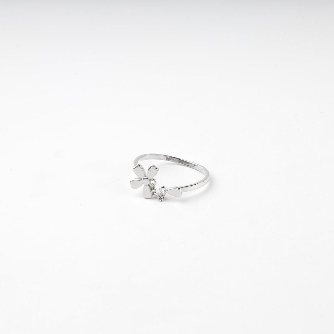 Flower ring lying flat showing the petals and the hanging charm