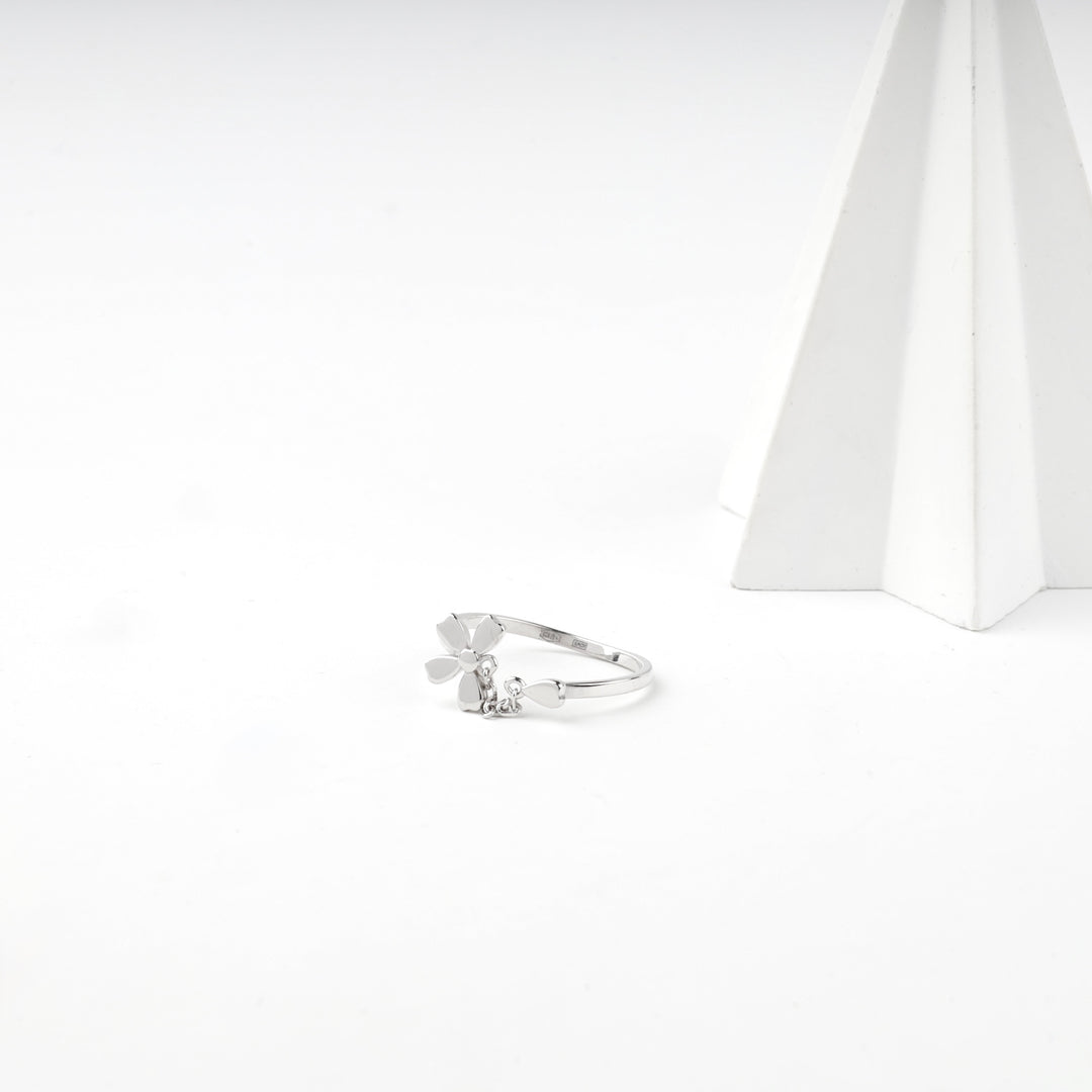 Angled view of the adjustable silver flower ring