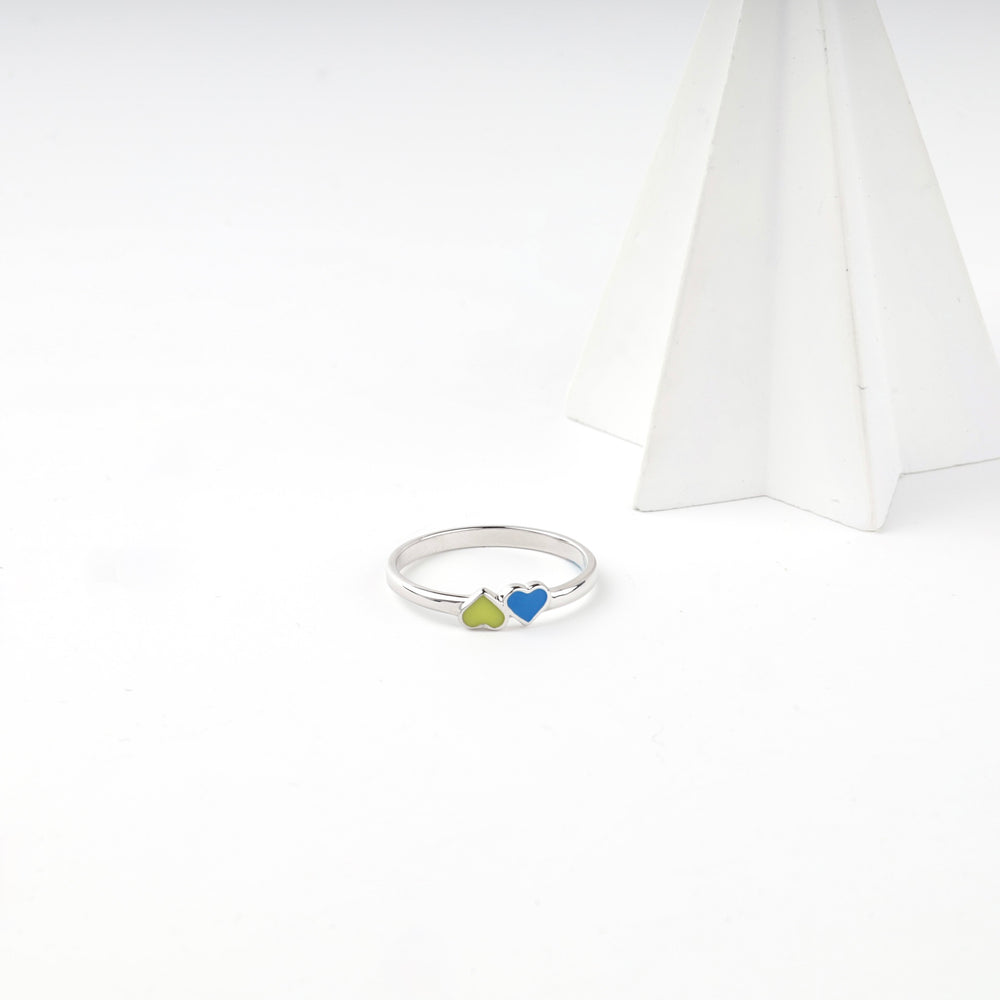 Angled view of the silver ring with the two enamel hearts