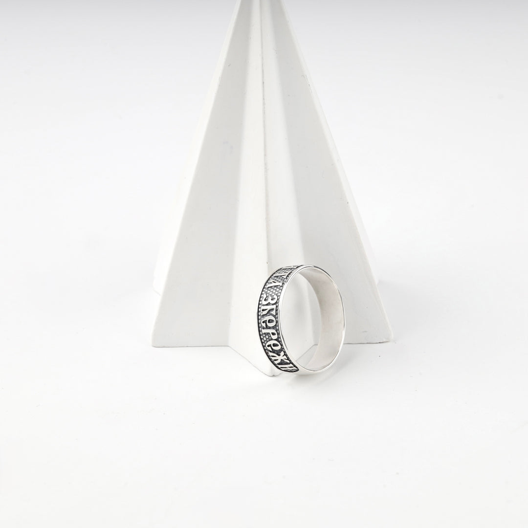 Sterling silver 925 protection ring standing against a white pyramid prop