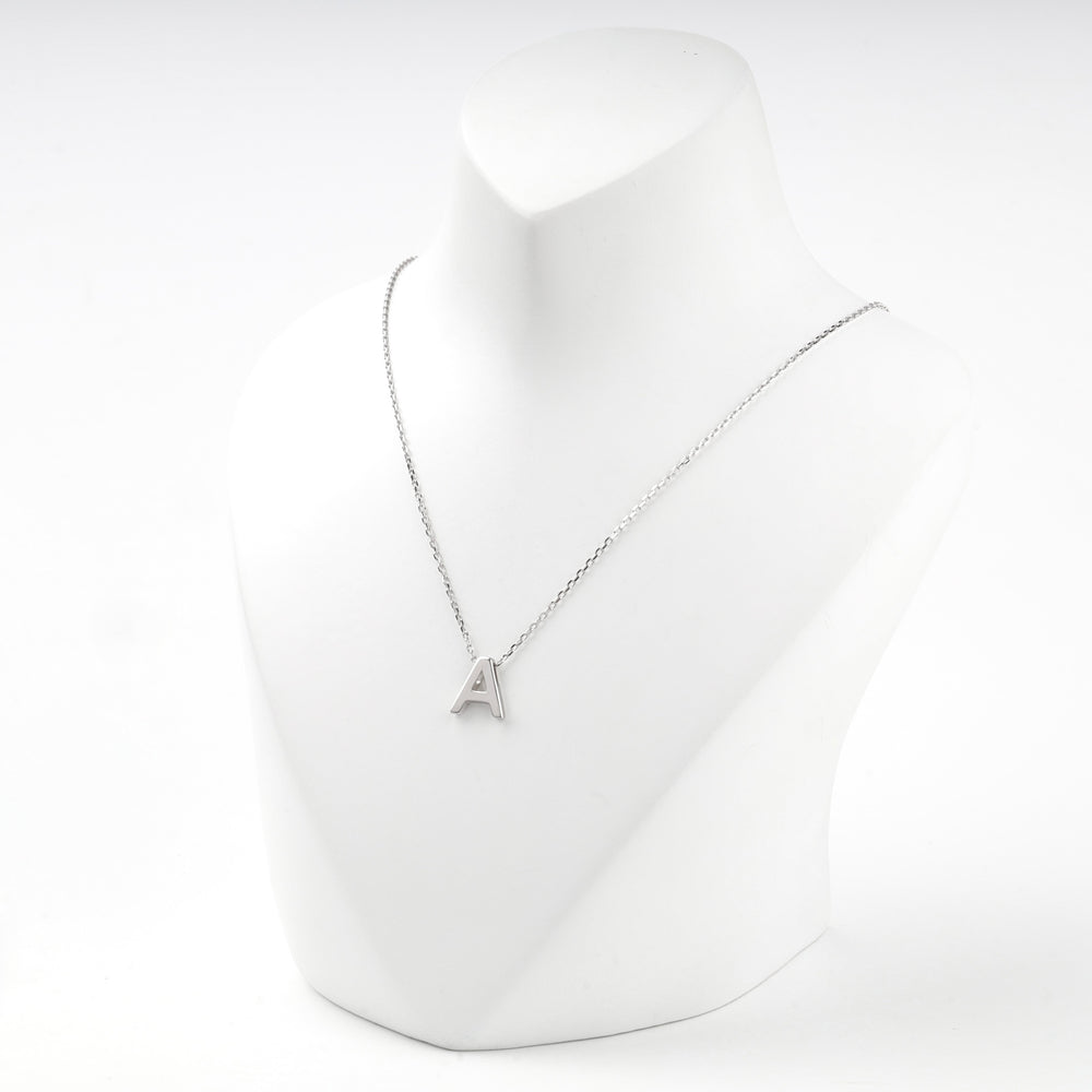 Letter A initial necklace worn on a white display bust