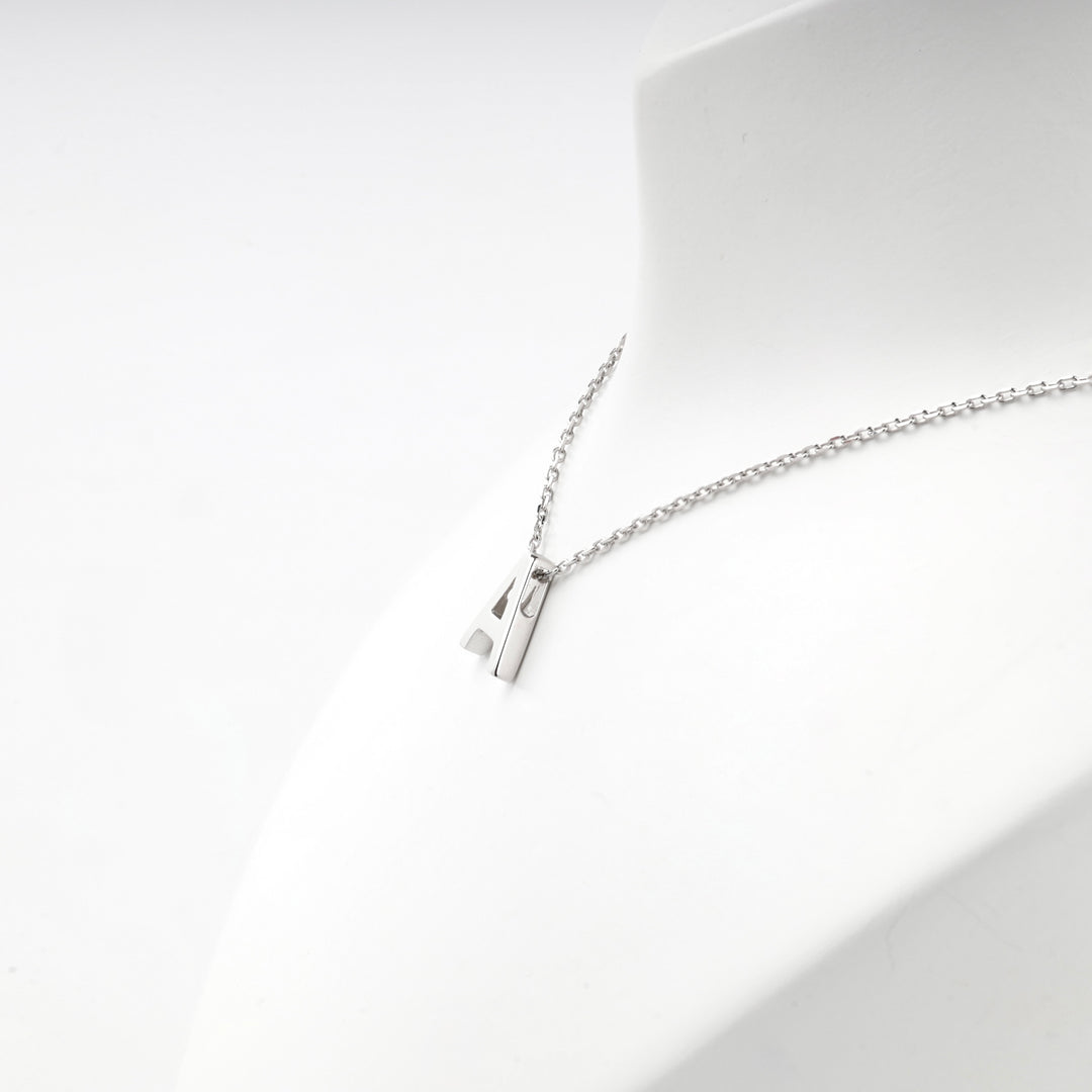 Angled view of the letter A pendant hanging from the chain