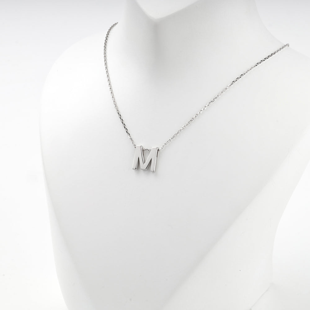 Close view of the silver letter M pendant on the fine anchor chain