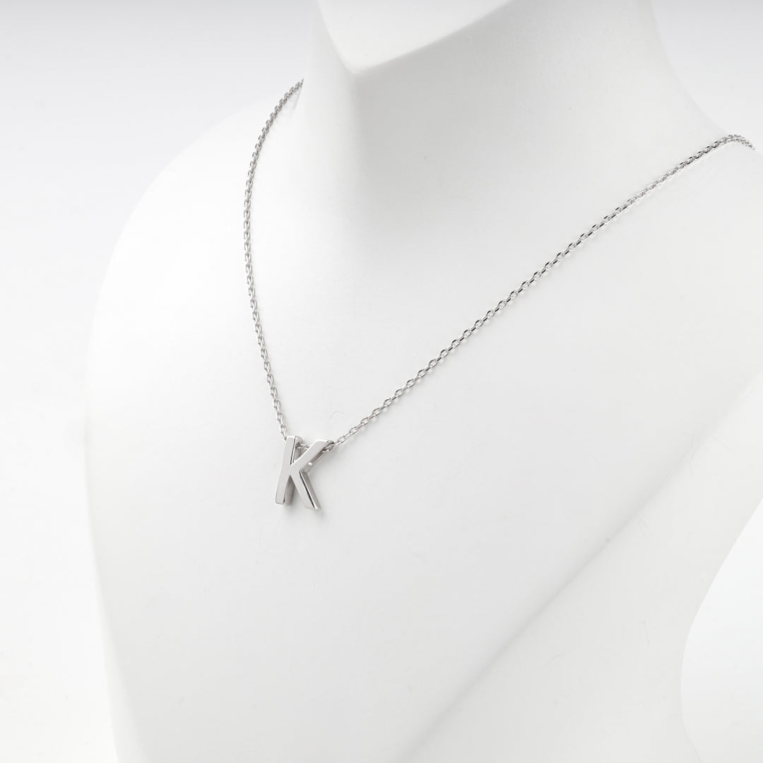 Close view of the silver letter K pendant on the fine anchor chain