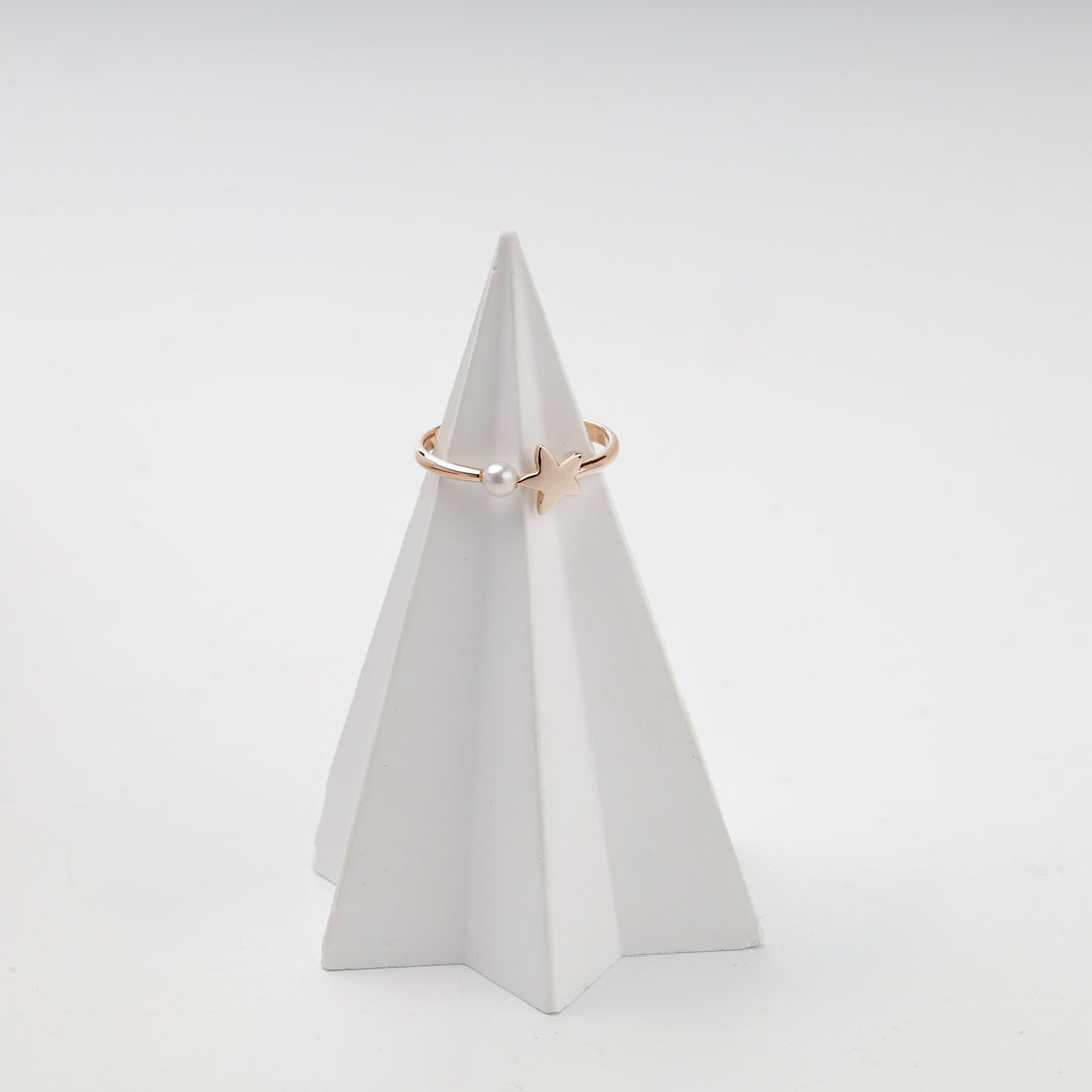 Rose gold bypass ring with star and pearl