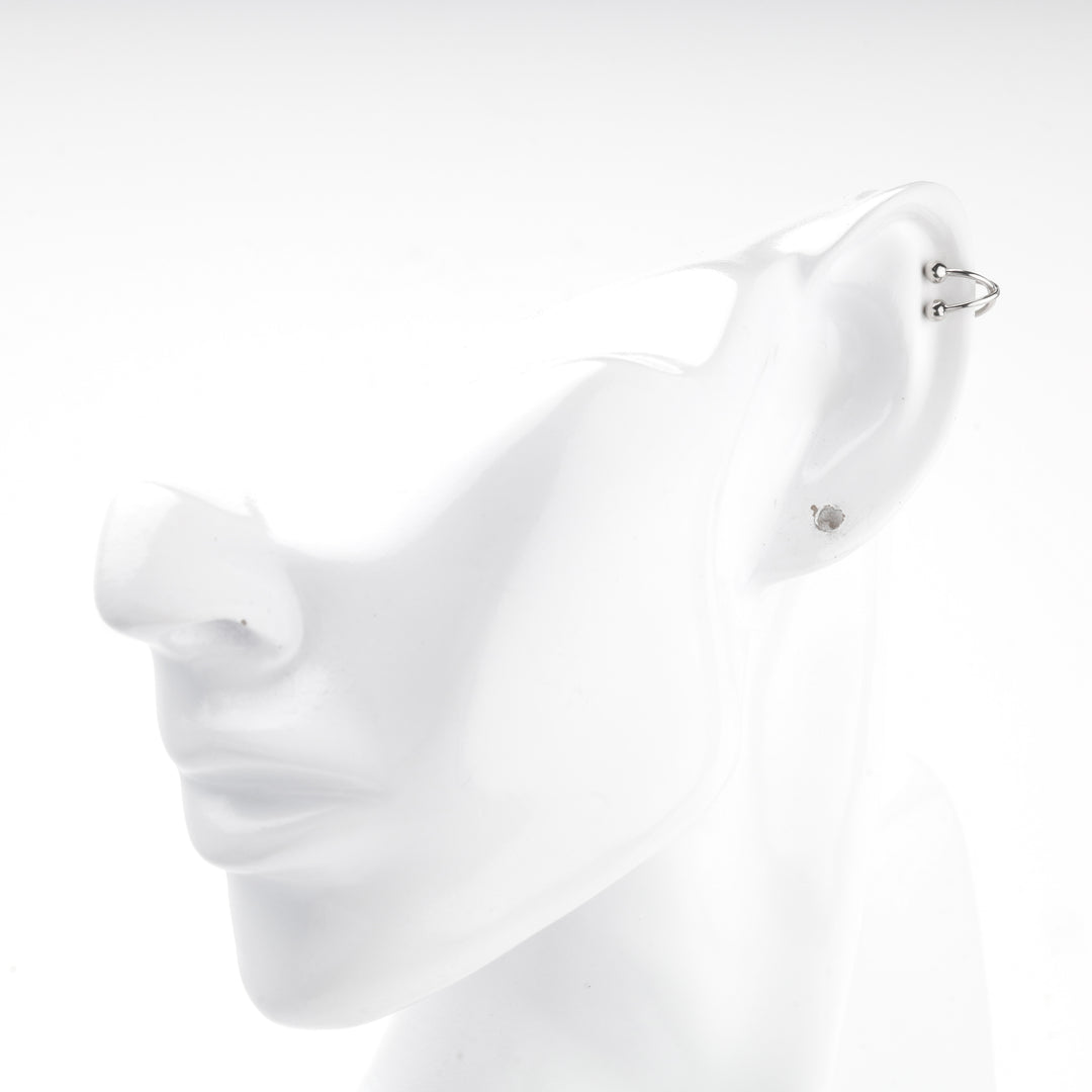 Silver 925 crossover ear cuff shown on a white mannequin ear