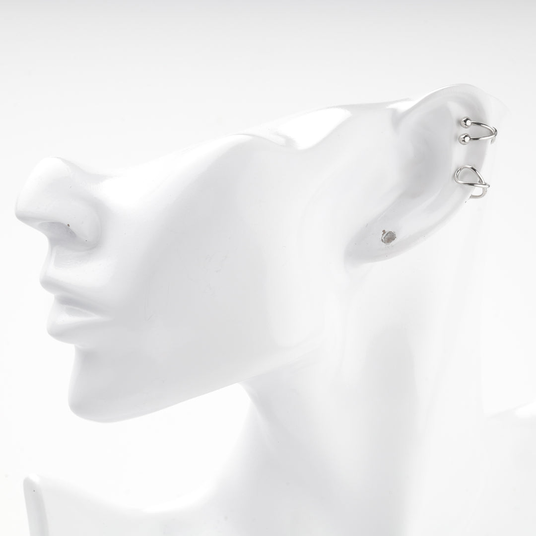 Two silver 925 ear cuffs worn together on a mannequin ear