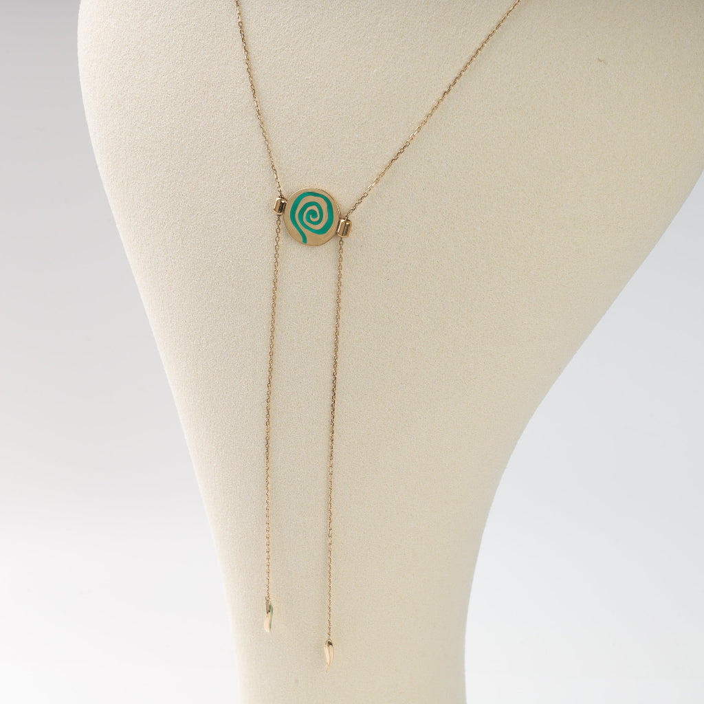 Necklace with a green spiral pendant on a mannequin bust.