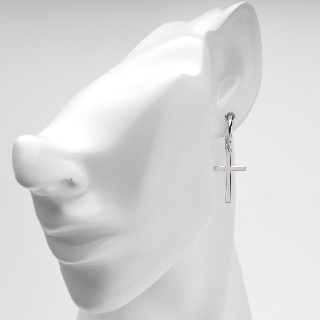 Silver 925 cross earring shown on a white mannequin ear