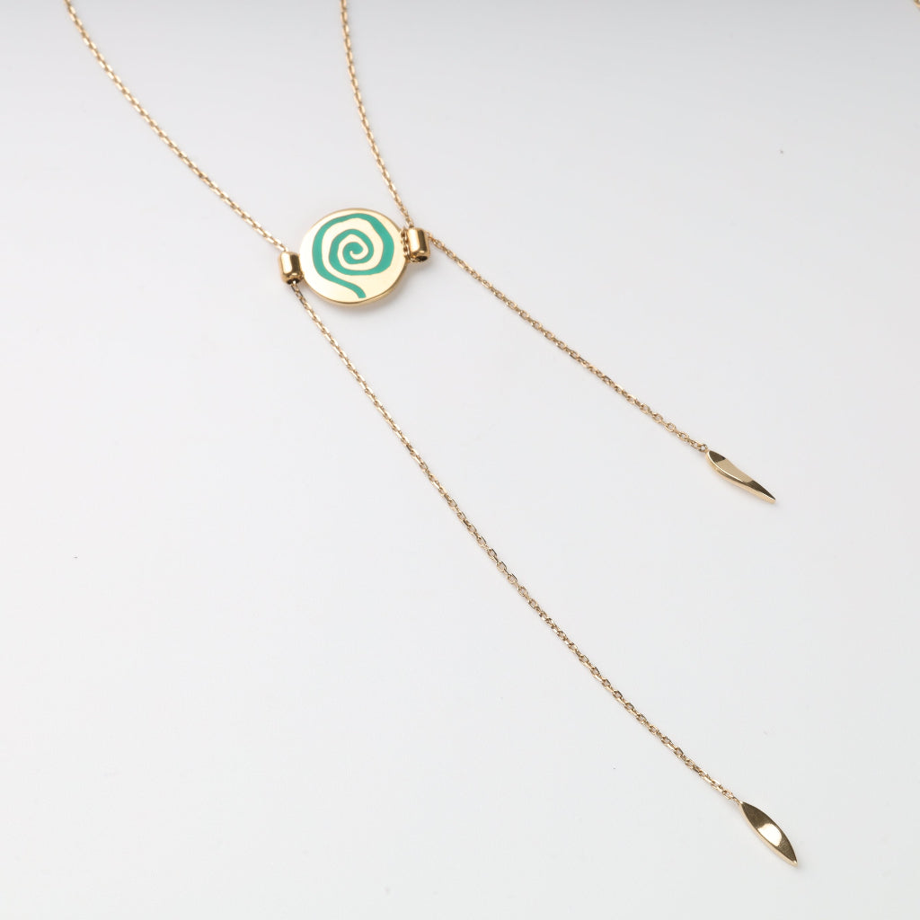 Gold necklace Mavka with a green spiral pendant on a white background