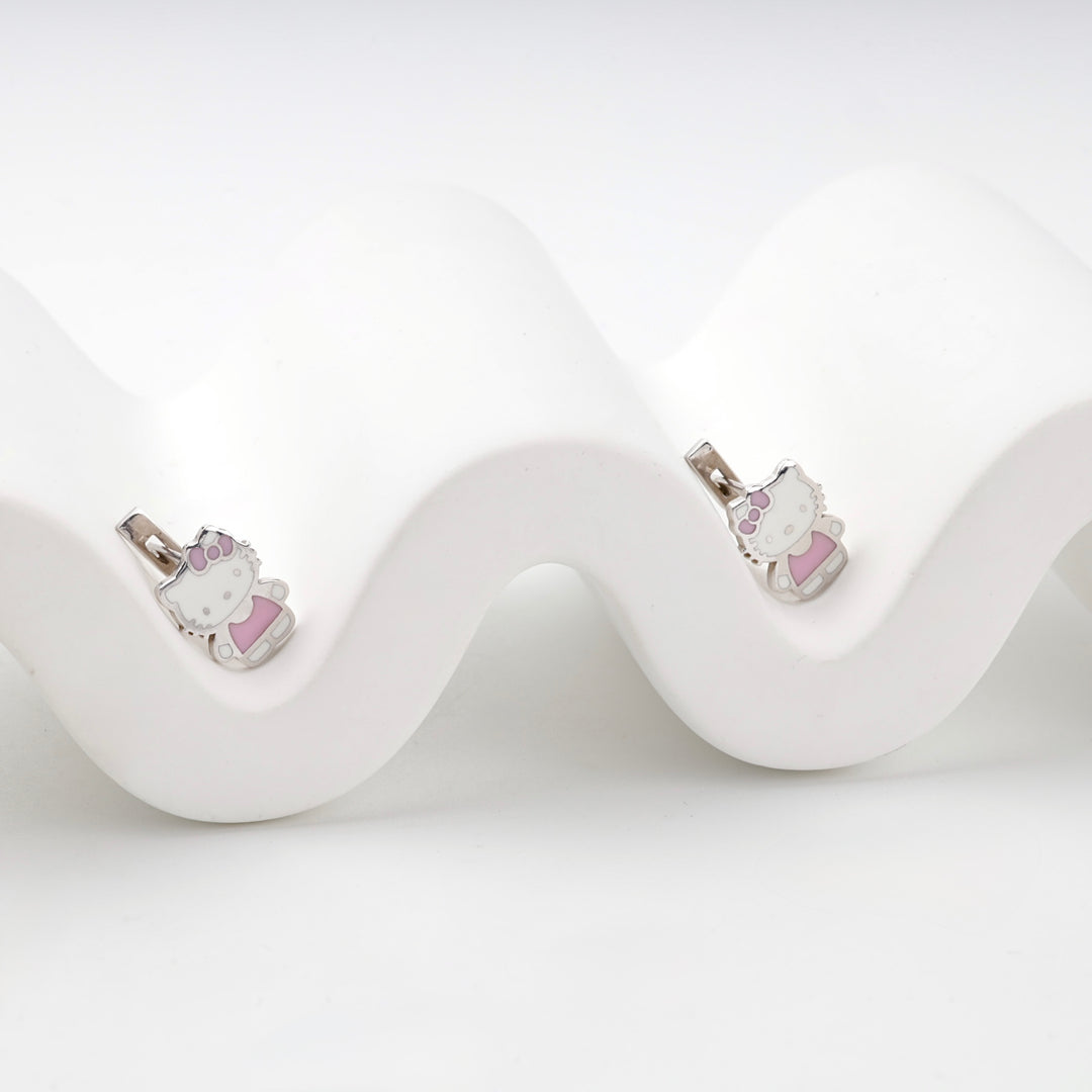 Silver 925 earrings with white and pink enamel cat figures on a wavy display