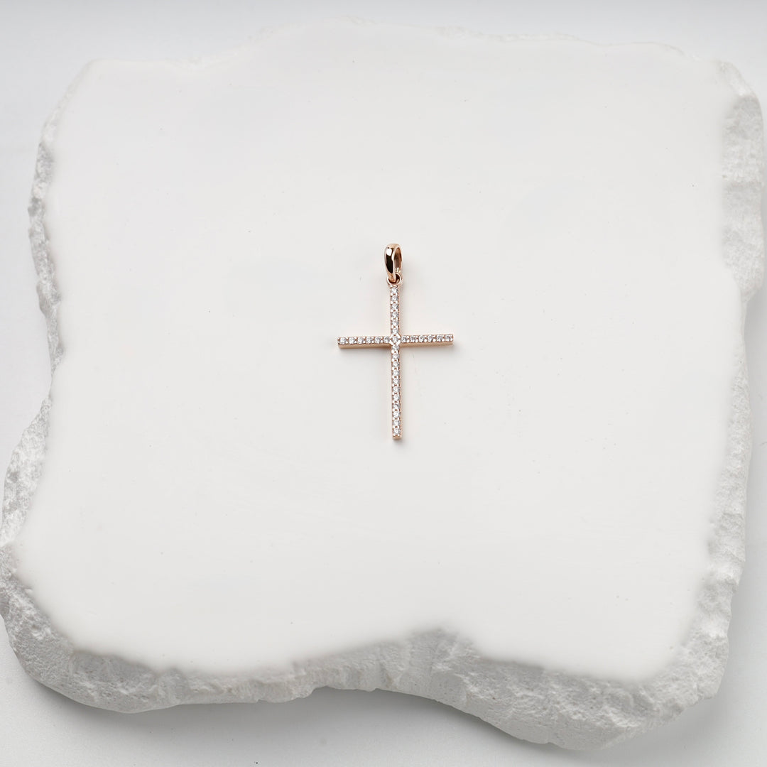 Long rose gold cross pendant with cubic zirconia, studio view