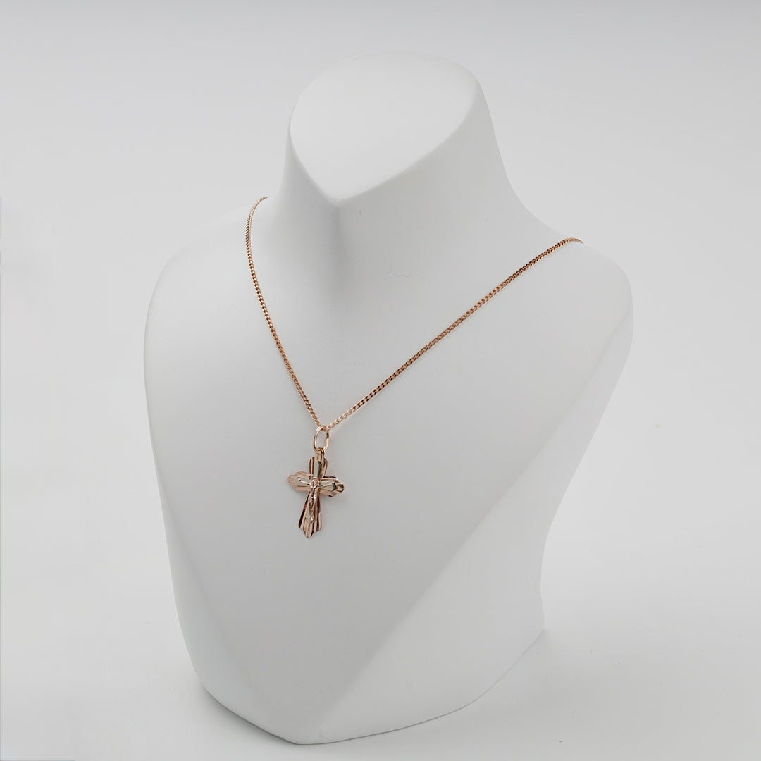 Rose gold Orthodox crucifix cross pendant worn on a chain