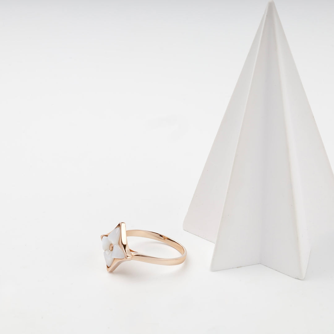 Rose gold star ring on white prop
