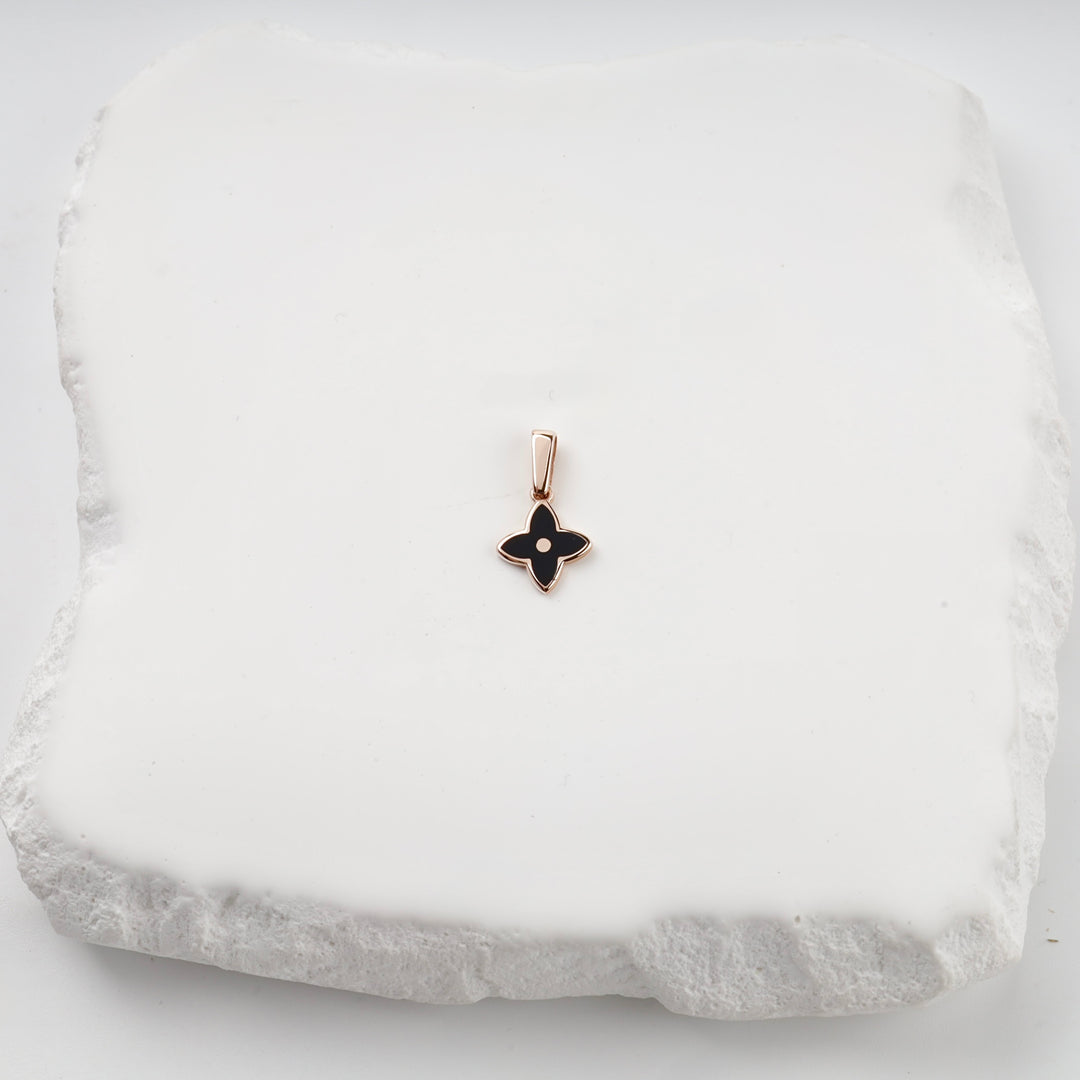 Rose gold black enamel flower pendant on white stone