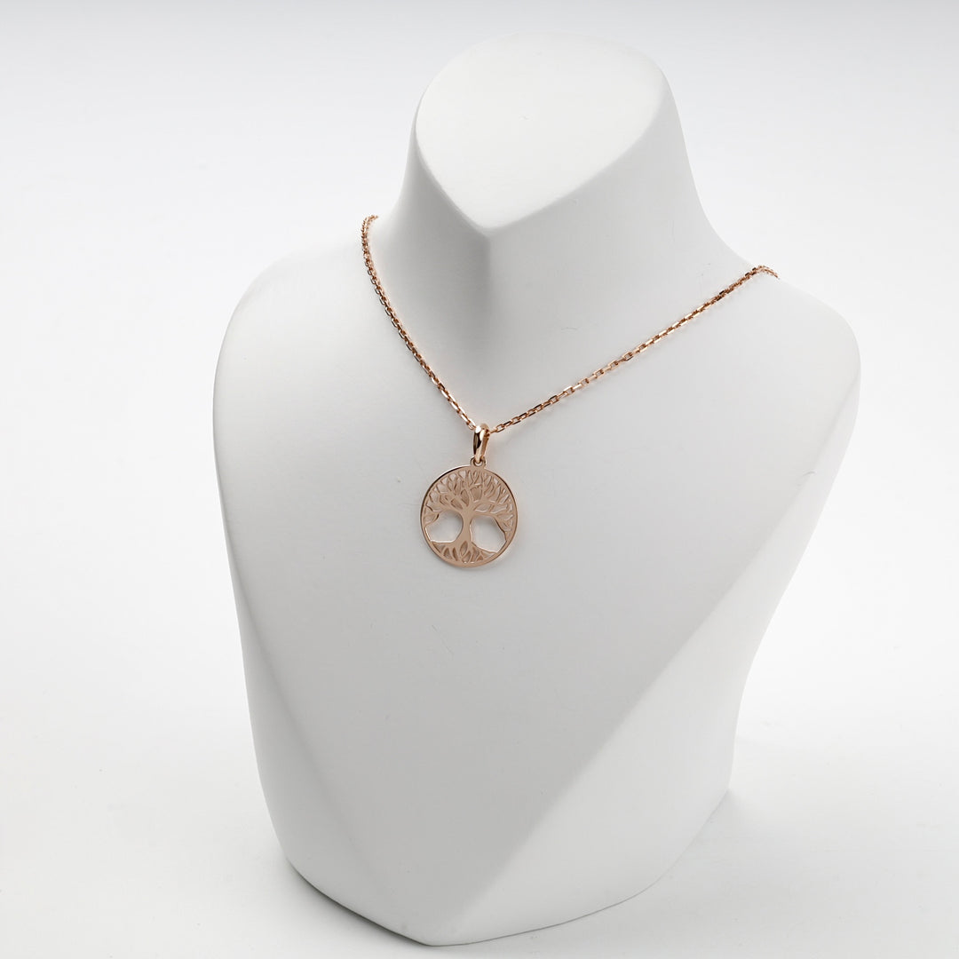 Rose gold tree of life medallion, studio view