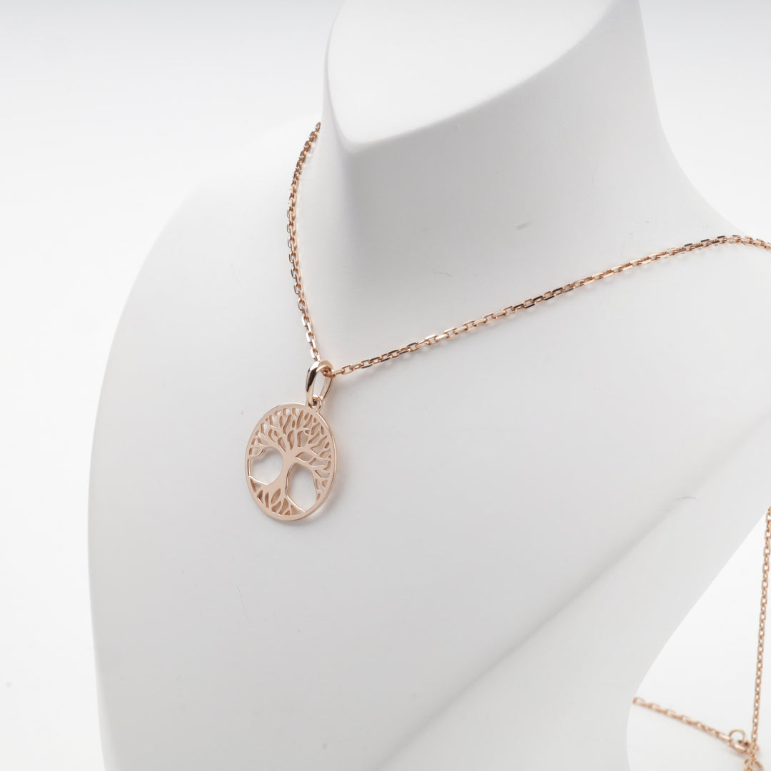 Round rose gold tree of life pendant, angled view