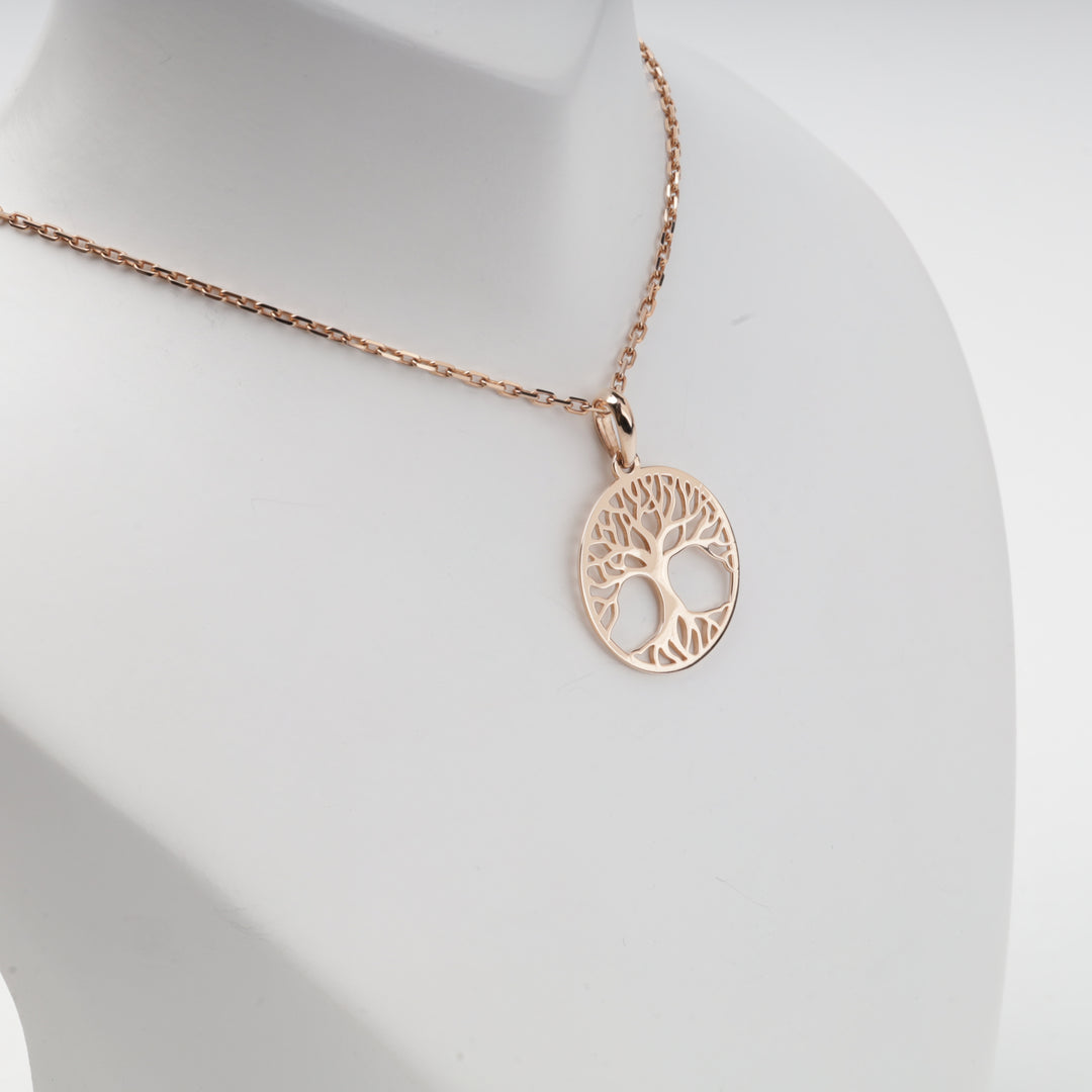 Rose gold tree of life pendant worn on a chain