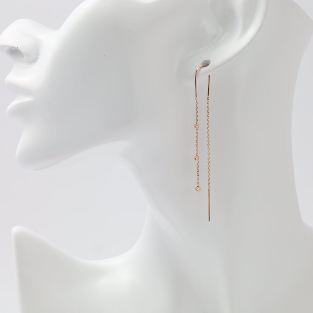 Rose gold threader earrings worn on ear | Ukrainian Jewelry