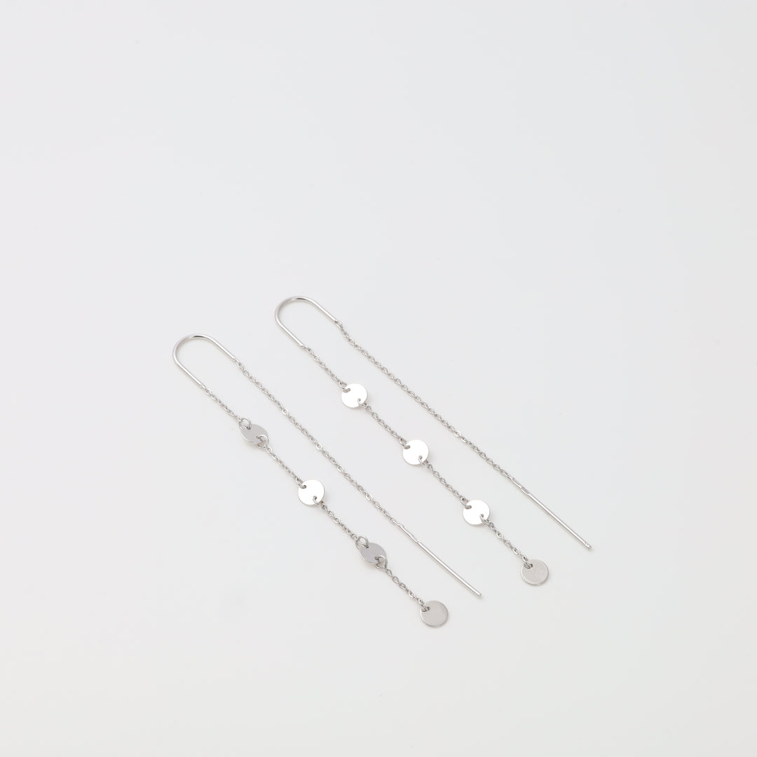 Silver necklace with small round pendants on a light gray background
