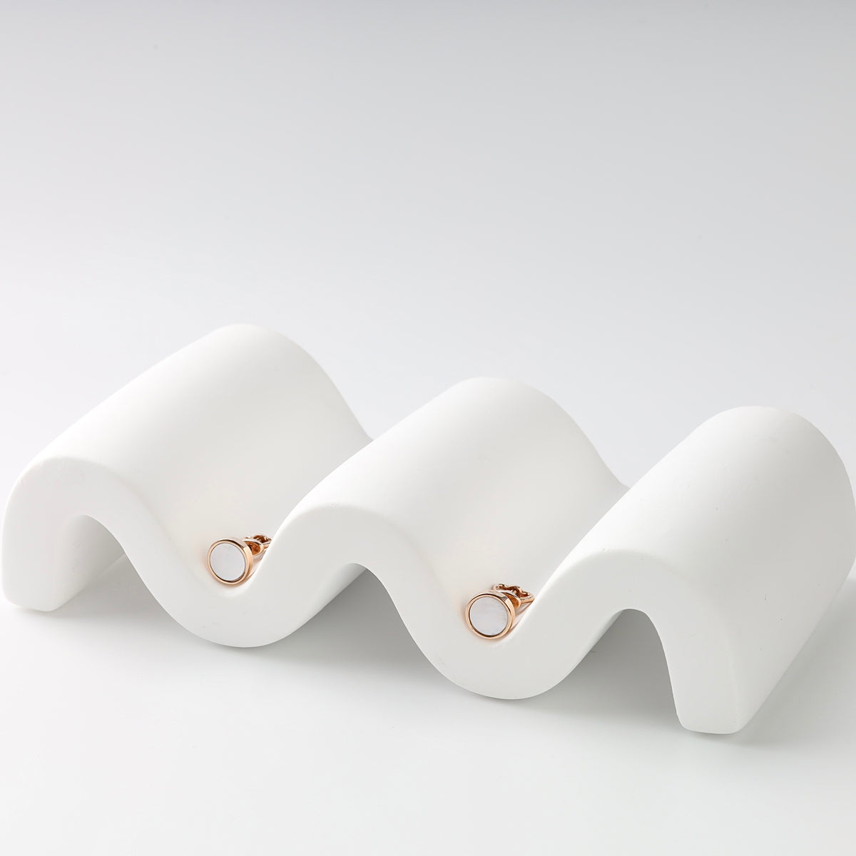 Round Mother of Pearl Stud Earrings in 14K Rose Gold — pair on white background