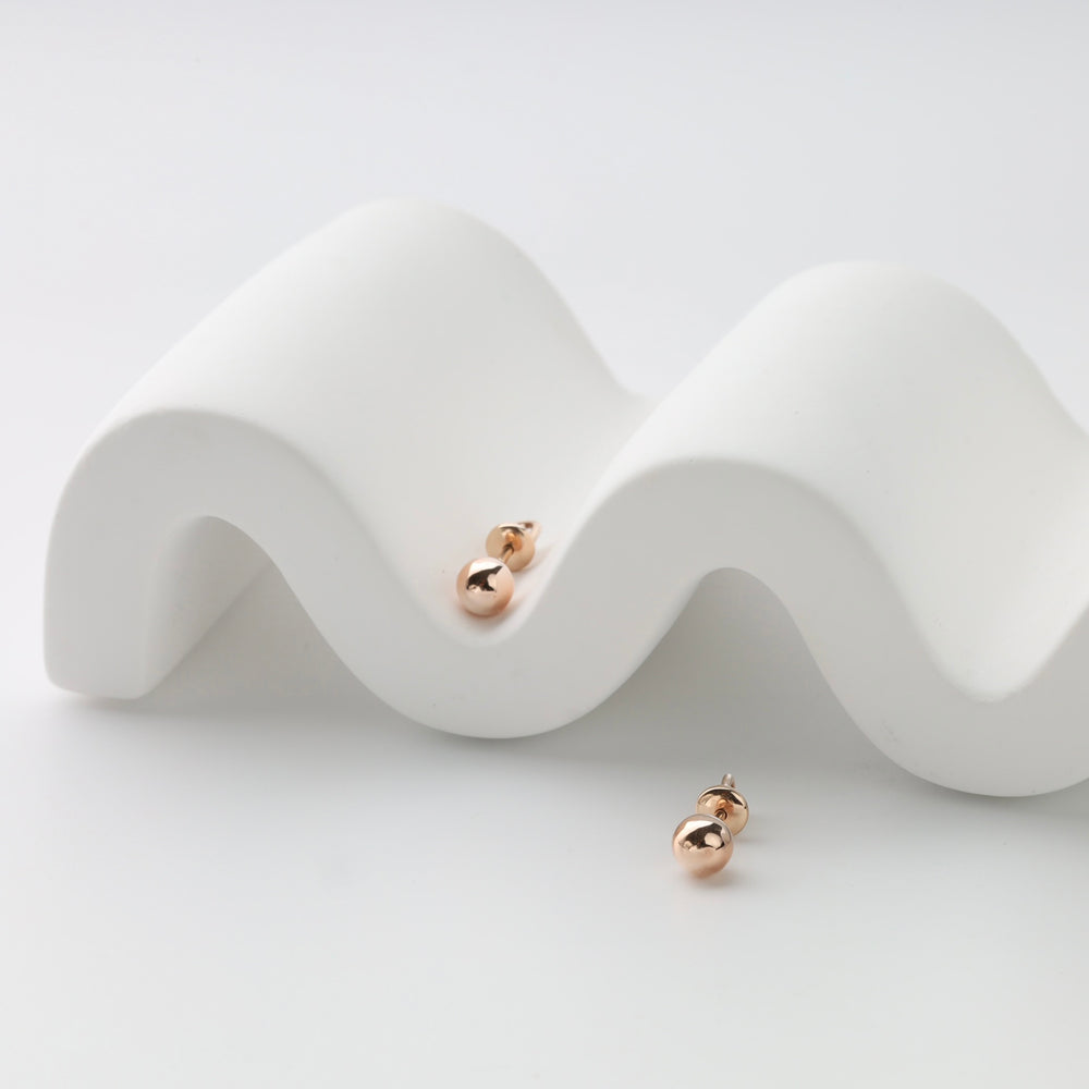 Rose gold ball stud earrings on display Ukrainian Jewelry