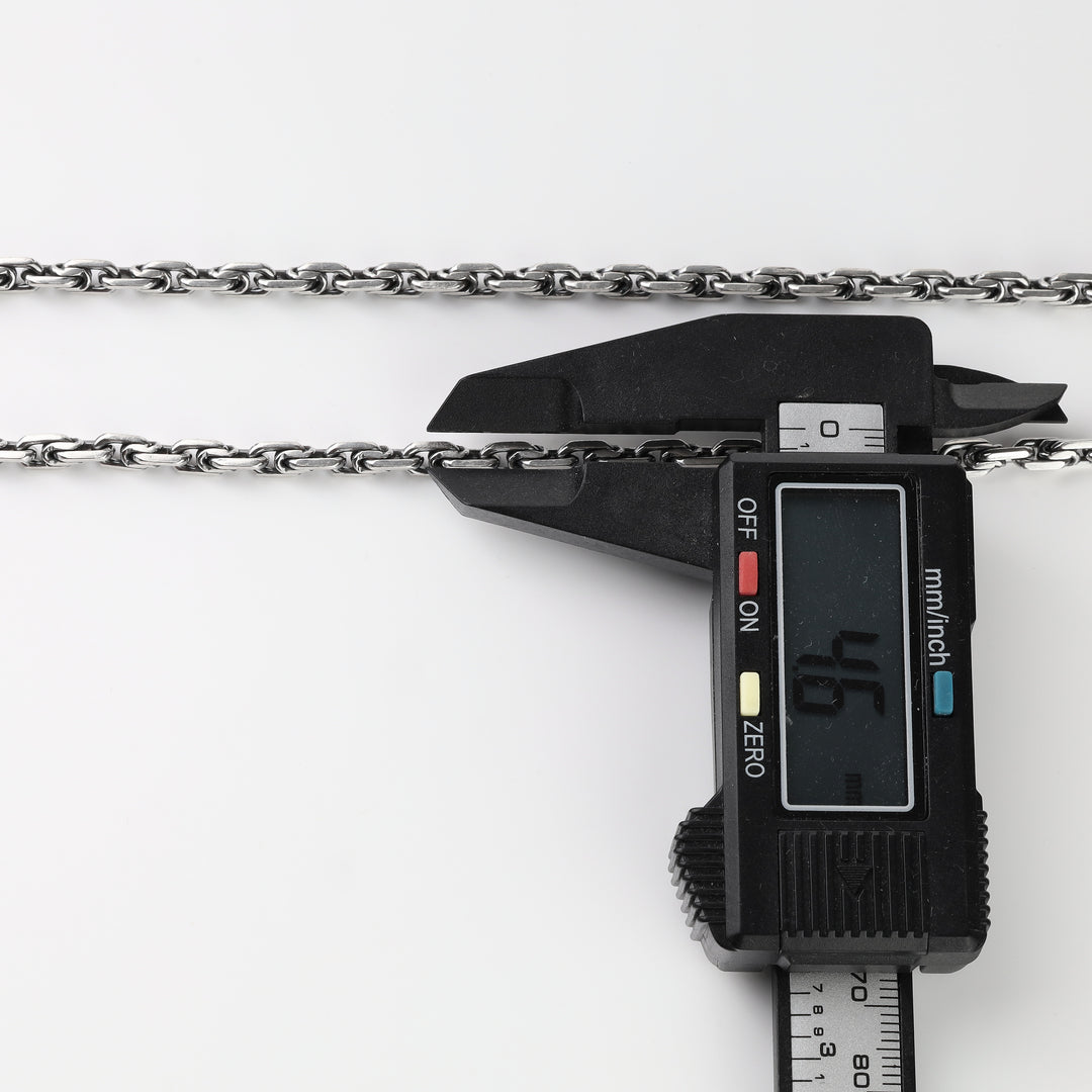 Silver anchor link chain width measured with a caliper at 4.6 mm
