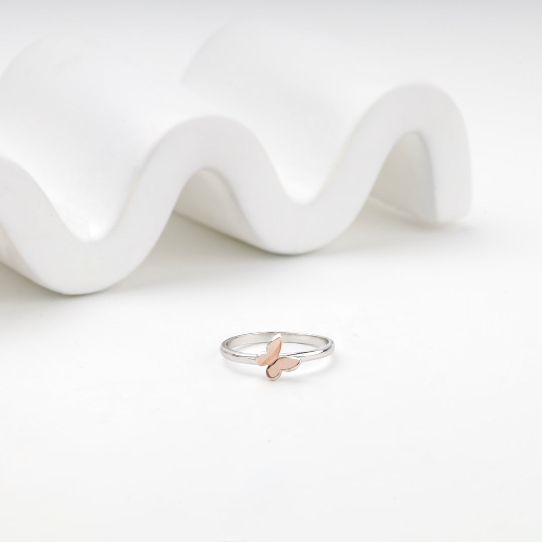 Silver 925 band ring with a rose gold butterfly seen from the front