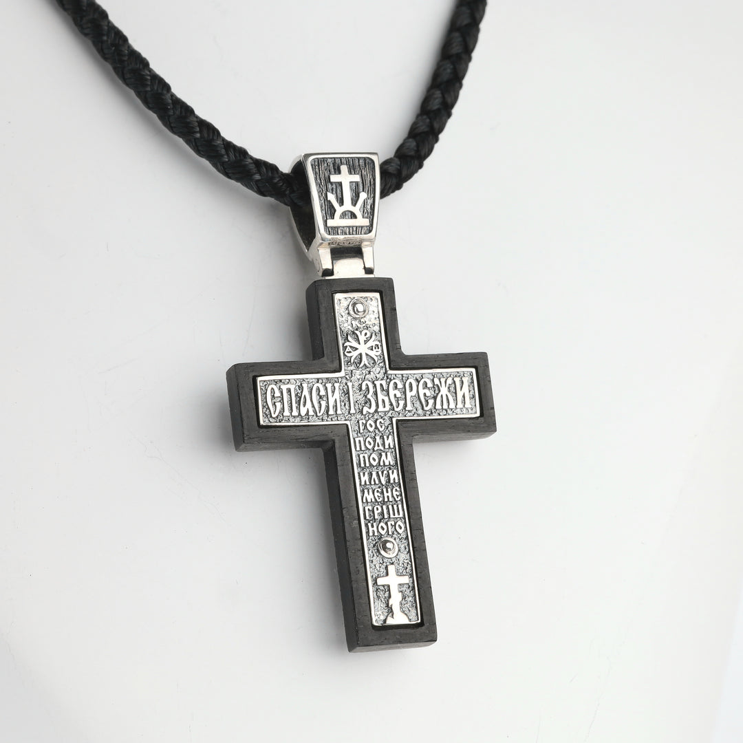 Wooden Orthodox crucifix pendant with silver overlay, angled view