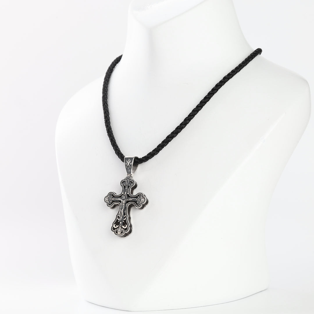 Silver crucifix pendant with crucified Christ relief and ebony backing
