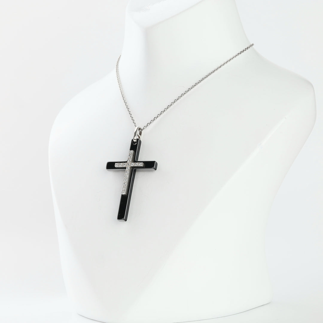 Black ceramic cross pendant on a silver chain on a bust