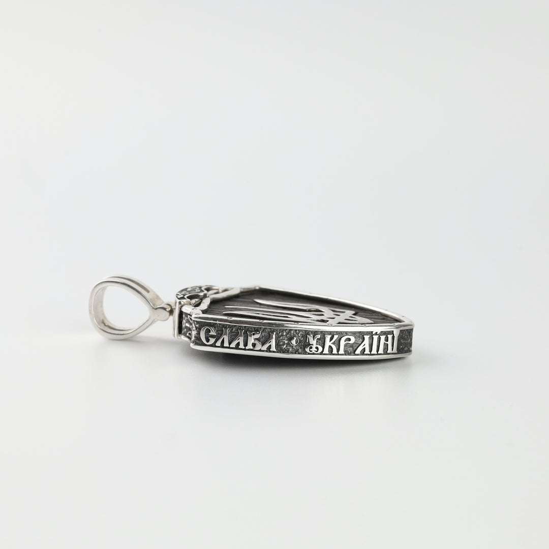 Side of silver shield pendant engraved Glory to Ukraine